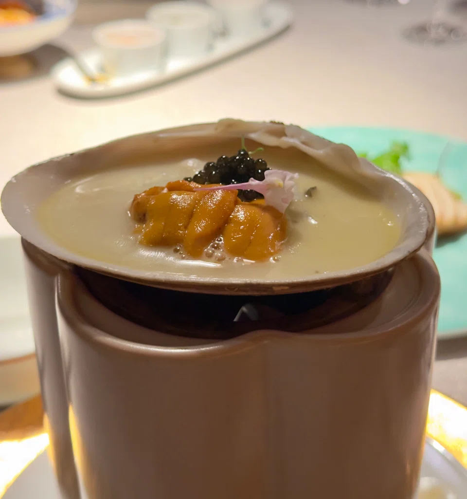A broth of clams, rice, uni and caviar.