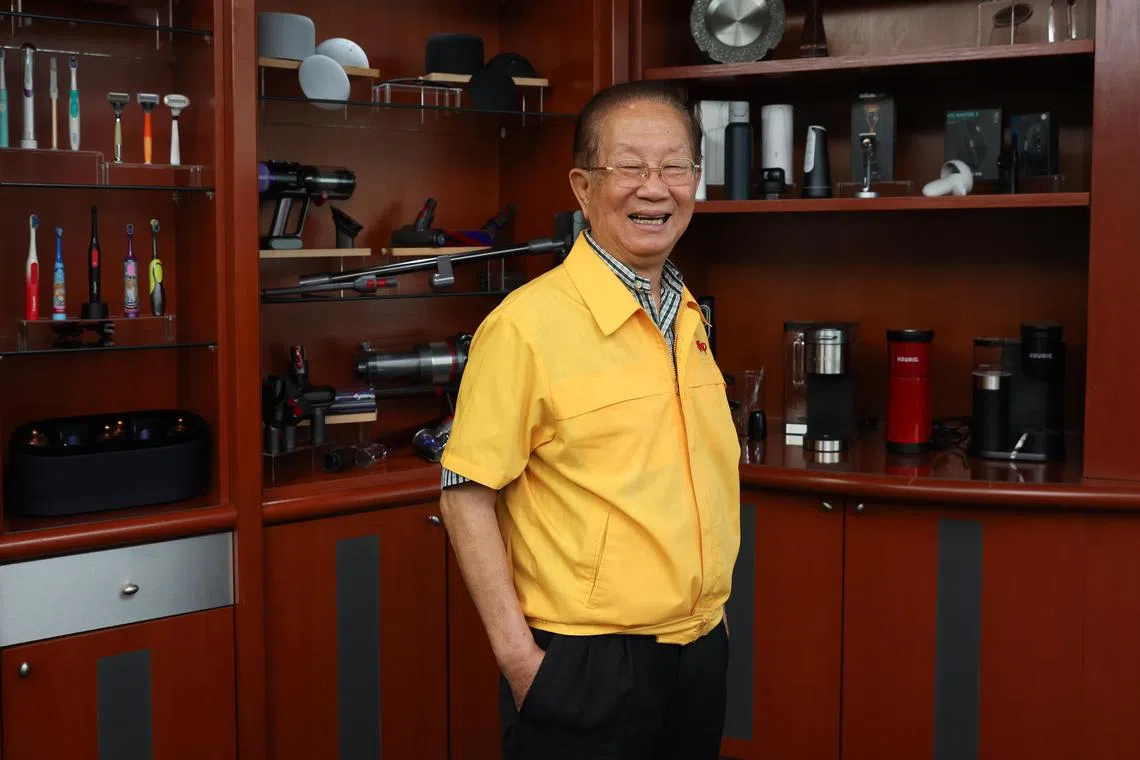 Yao Hsiao Tung, executive chairman of Hi-P Group, framed by products the company has helped to manufacture, either as components or whole products, including Dyson vacuum cleaners and Keurig coffee makers.