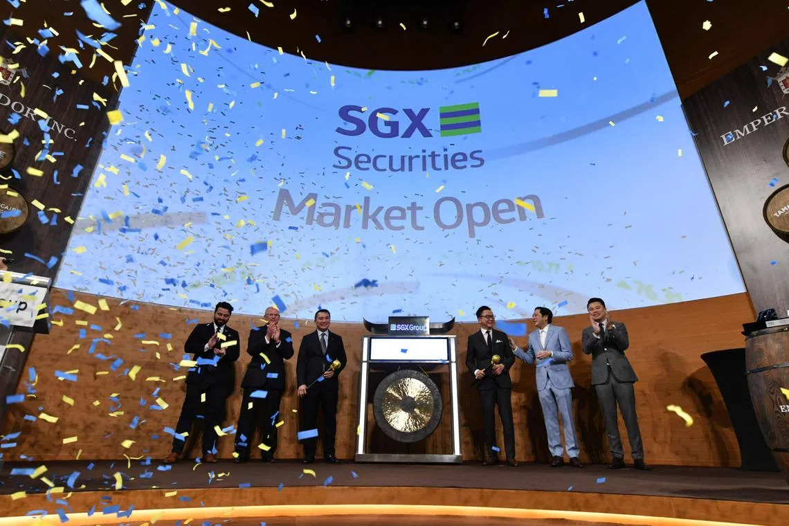 (From left) George Schulze, Dalmore whisky expert for Asia at Emperador; Bryan Donaghey, chief executive of Whyte & Mackay and head of whisky business at Emperador; Loh Boon Chye, SGX chief executive; Dr Andrew Tan, chairman of Emperador; Gerard Ho, Singapore’s Ambassador to the Philippines and Kevin Andrew Tan, director of Emperador at the listing of Emperador at the Singapore Exchange on 14 July 2022.