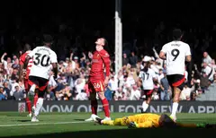 Liverpool's Andrew Robertson (centre) reacts after Fulham's Alex Iwobi scores their second goal at Craven Cottage, London, Britain, April 6, 2025.