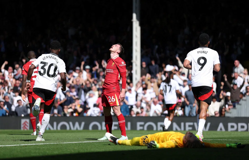 Liverpool's Andrew Robertson (centre) reacts after Fulham's Alex Iwobi scores their second goal at Craven Cottage, London, Britain, April 6, 2025.