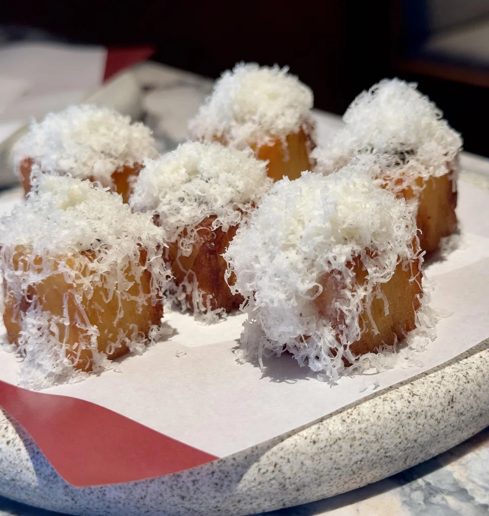 Perfect bites of potato paves showered with grated cheese.