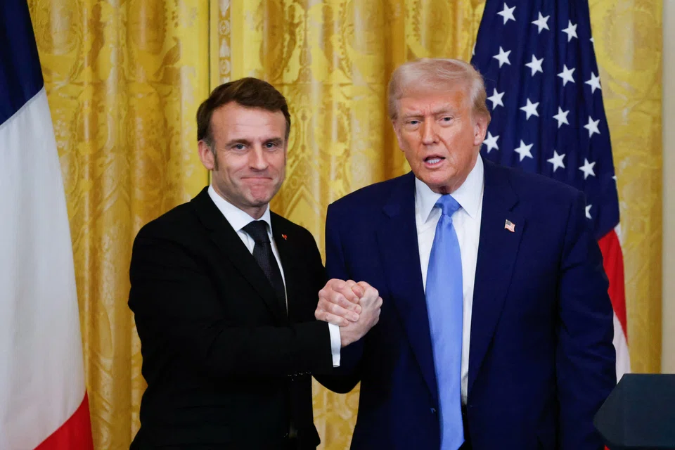 US President Donald Trump (right) and French President Emmanuel Macron (left) shake hands at the end of a joint press conference in the White House in Washington, D.C., Feb 24, 2025. 