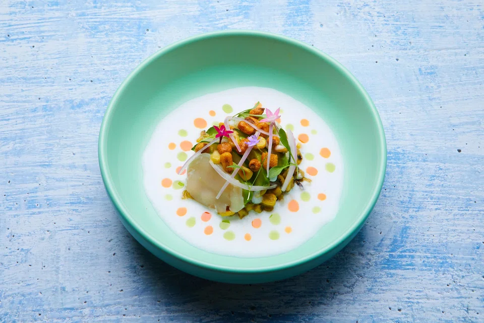 Cold curry ceviche features scallops, avocado and corn in a thick coconut cream sauce.