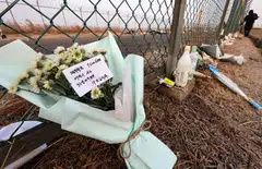 Tributes placed along a fence near the site where a Jeju Air Boeing 737-800 aircraft crashed and burst into flames at Muan International Airport in Muan, South Korea, Jan 2, 2025.