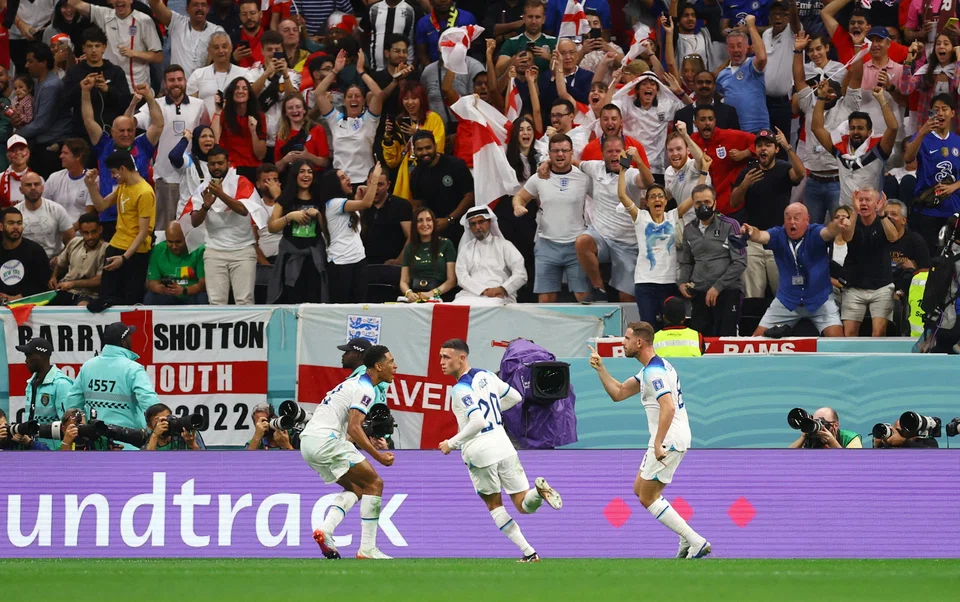 England's Jordan Henderson celebrates scoring their first goal with Jude Bellingham and Phil Foden at the Al Bayt Stadium, Al Khor, Qatar, Dec 5, 2022.      