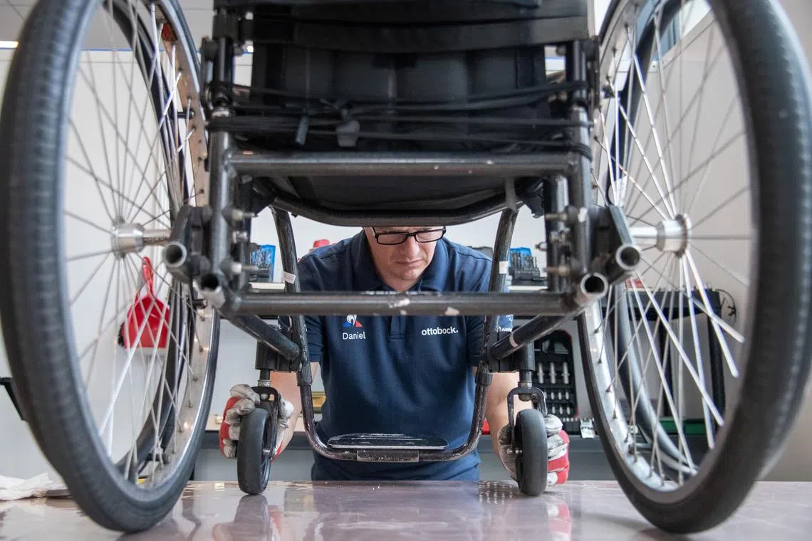 A technician repairing a wheelchair at the Paralympic Games’ fix-it shop in Paris. Run by German company Ottobock, technicians weld, sew and saw athletes’ assistive equipment into top shape.