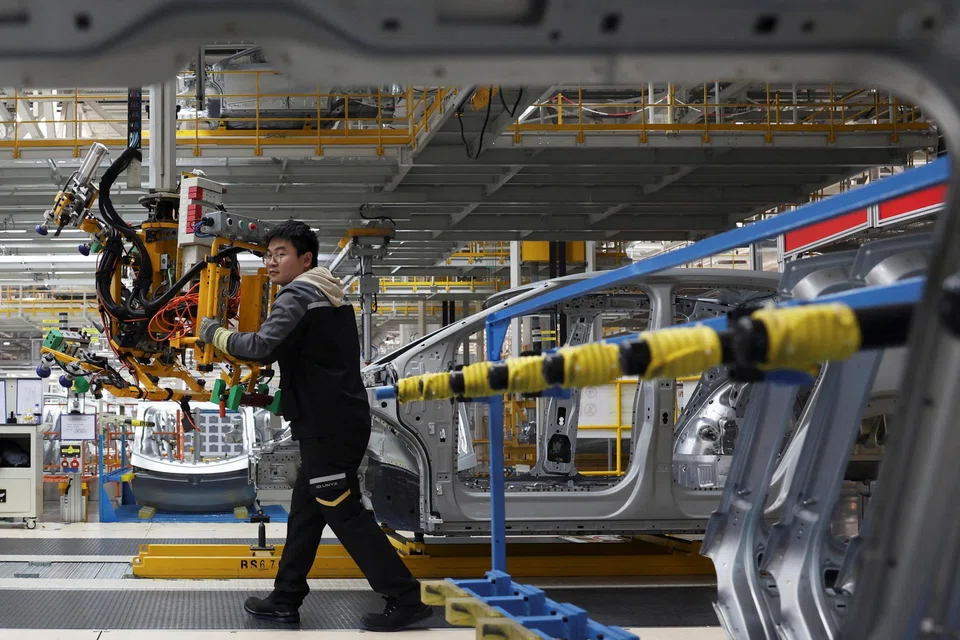 An employee works an electric vehicle production line at the Volkswagen Anhui factory in Hefei, China, Feb 4, 2026.