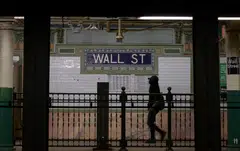 A person walks through the Wall Street subway station near the New York Stock Exchange. On Jun 15 at the end of the central bank’s 2-day policy meeting, Fed chairman Jerome Powell’s rate-setting committee boosted interest rates by three-quarters of a percentage point, the largest hike since 1994.