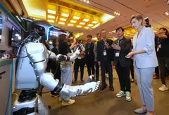 Minister for Digital Development and Information Josephine Teo (first from right) touring Mumtos at ST Engineering's InnoTech Conference on Sep 4. She noted the need for people to acquire AI-related skills.