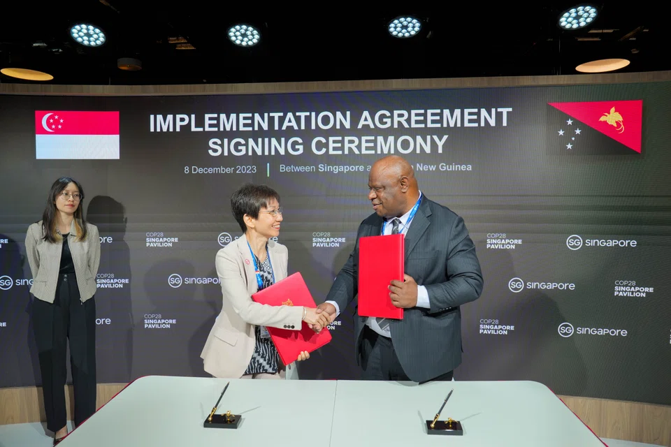 Singapore Minister for Sustainability and the Environment Grace Fu (left) and Papua New Guinea Minister of Environment, Conservation and Climate Change Simon Kilepa at the signing ceremony of the implementation agreement between the two countries.