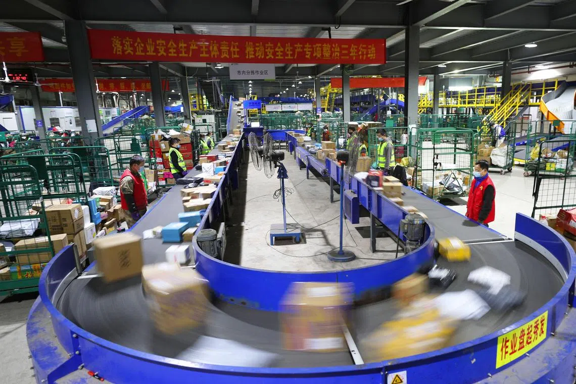 Workers sort packages at a logistics company in Hengyang in China's central Hunan province, a day after "Singles' Day'' in November. Topline growth in China's ecommerce sector has slowed significantly, and the sector is in a long and dark winter.