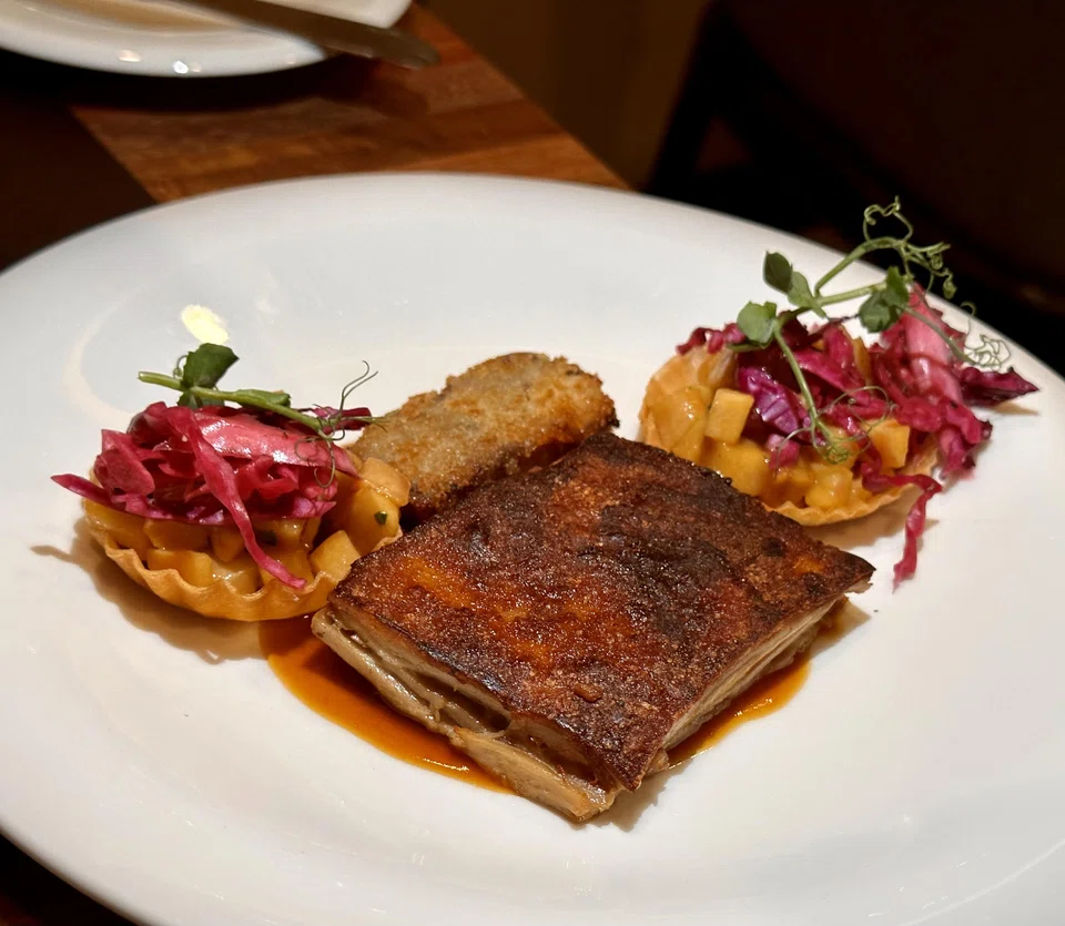 Suckling pig is paired with pork head terrine and tangy apple tart.