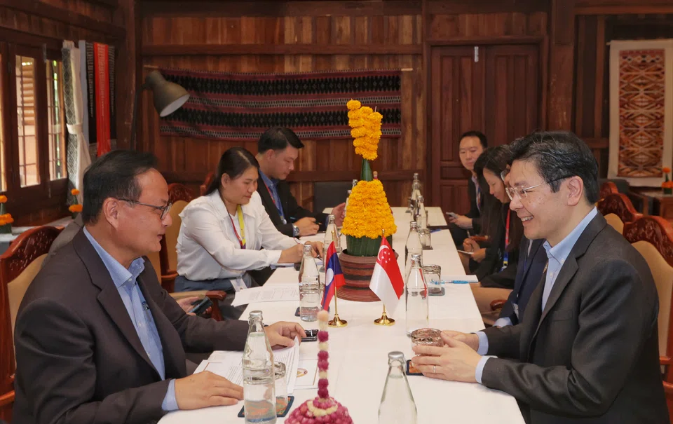 DPM Lawrence Wong (right) and Lao Minister of Finance Santiphab Phomvihane discuss strengthening economic ties and deepen collaboration.