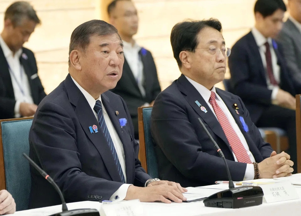 Japan's Prime Minister Shigeru Ishiba speaks next to Economic Revitalization Minister Ryosei Akazawa during a meeting with cabinet ministers to discuss Japan's strategy in dealing with U.S. tariffs, at Ishiba's official residence in Tokyo.