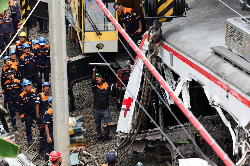 Rescuers at work after a deadly collision between a commuter line train and a long-distance train in Bekasi, Indonesia, April 28, 2026. 