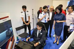 Senior Minister of State for Transport and National Development Sun Xueling and Civil Aviation Authority of Singapore (CAAS) director-general Han Kok Juan (right) touring the OneAviation Careers & Education Fair 2025 on Jul 18.