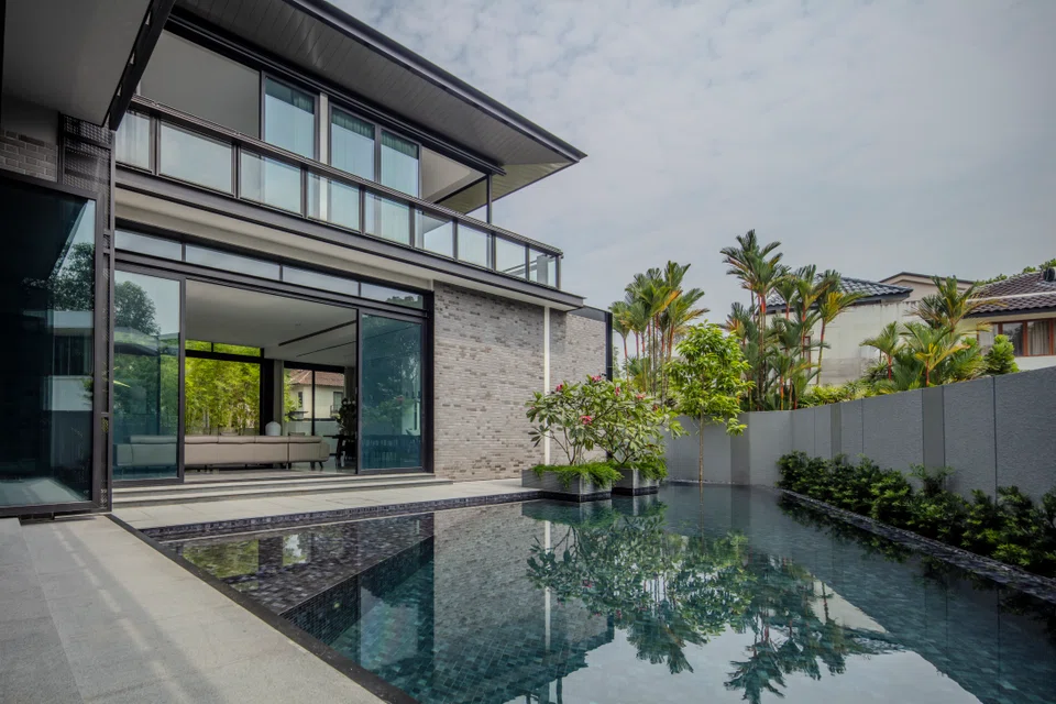 The living and dining rooms open out onto the pool. Viewed from this angle, perspective lines give the trapezoid-shaped pool an unintended infinity effect.