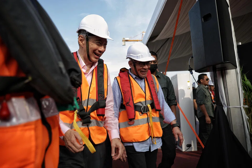 Malaysia Prime Minister Anwar Ibrahim (right) and Singapore Prime Minister Lee Hsien Loong attending a commemorative event for the completion of the connecting span of the Johor Bahru-Singapore Rapid Transit System Link on Thursday.