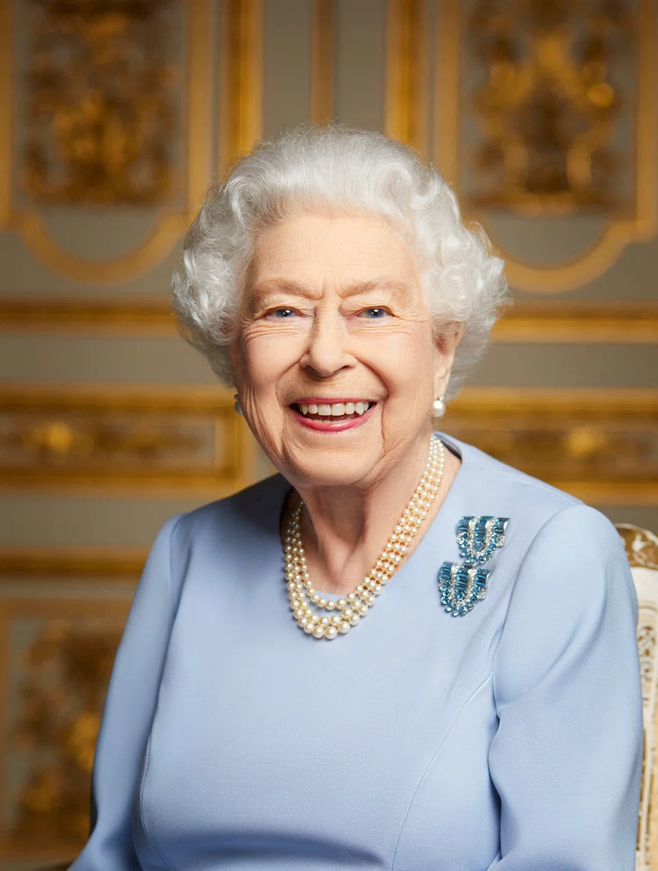 A new  image released by Buckingham Palace on September 18, 2022, shows Britain's Queen Elizabeth II smiling, photographed at Windsor Castle in May 2022. Huge crowds built in central London from early morning on September 19, 2022, to secure a spot to watch the state funeral of Queen Elizabeth II at Westminster Abbey. 