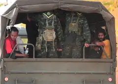 People who were rescued from scam centres in Myanmar travelling inside a military truck. 