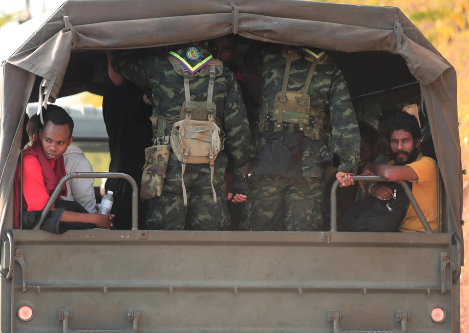 People who were rescued from scam centres in Myanmar travelling inside a military truck. 