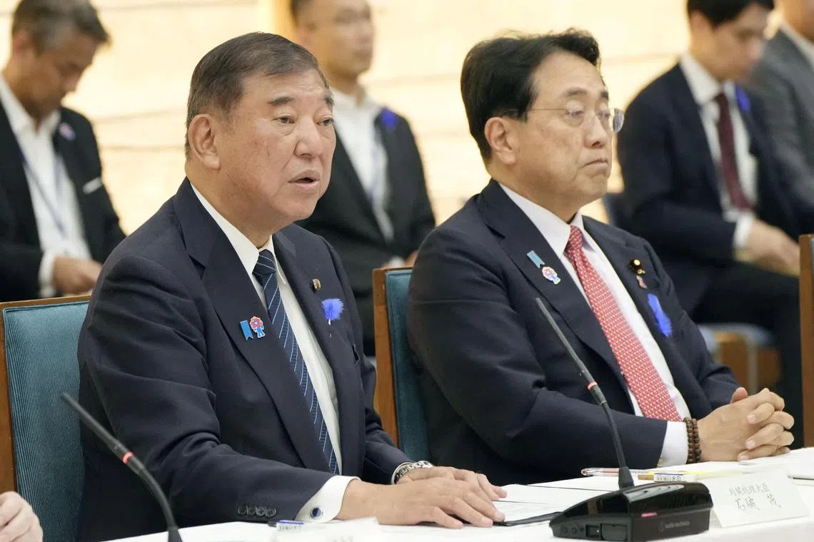 Japan's Prime Minister Shigeru Ishiba speaks next to Economic Revitalization Minister Ryosei Akazawa during a meeting with cabinet ministers to discuss Japan's strategy in dealing with U.S. tariffs, at Ishiba's official residence in Tokyo.