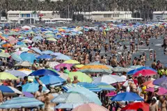 People crowd a beach during a hot day in Valencia, Spain, Aug 11, 2024. High temperatures, exceeding 40 deg C in some parts of Spain, are being recorded in a new heatwave, the fourth of the summer.  