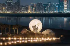 Kaws' massive Companion sculpture makes a splash at Souq Al Mina waterfront.