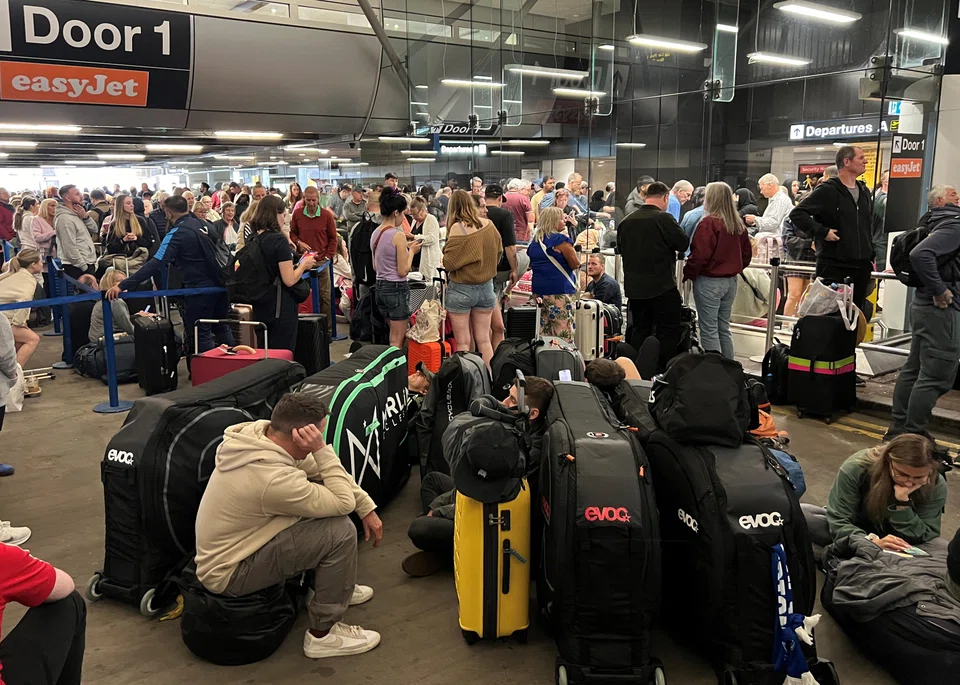 Passengers queueing outside Terminal 1 at Manchester Airport after an issue with the power supply affected the airport and a number of other buildings.