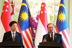 Prime Ministers Lawrence Wong (left) and Anwar Ibrahim speaking to reporters on Jan 7, 2025, during a press conference in Putrajaya.