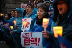 Demonstrators calling on President Yoon Suk Yeol to step down after his brief imposition of martial law in South Korea outside the National Assembly building in Seoul, South Korea, Dec 5, 2024. 
