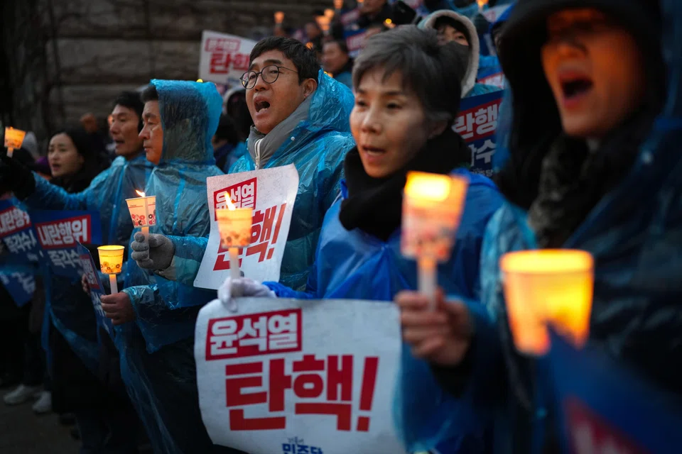 Demonstrators calling on President Yoon Suk Yeol to step down after his brief imposition of martial law in South Korea outside the National Assembly building in Seoul, South Korea, Dec 5, 2024. 