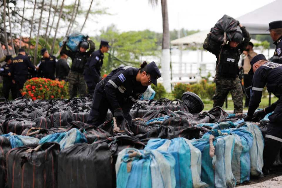 Law enforcement officers arrange bundles of cocaine after drug seizures by the Salvadoran Naval Force on Monday. The UNODC report painted a bleak picture of the worldwide battle against illegal drugs and the criminals behind them.