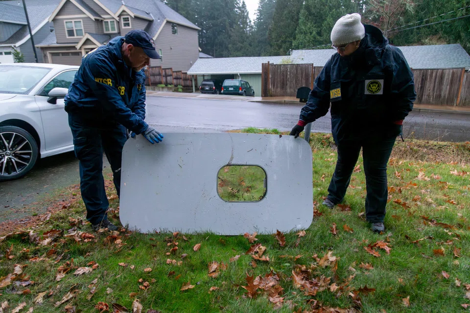 National Transportation Safety Board investigators examine the fuselage plug that fell off the Alaska Airlines Boeing 737 MAX 9,  at a site where it was recovered in Portland, Oregon, on Jan 8.
