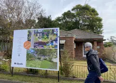 FILE PHOTO: A man walks past a derelict home, which sold for A$1.6 million, in Sydney's northwest in Australia June 23, 2021. REUTERS/Swati Pandey/File Photo