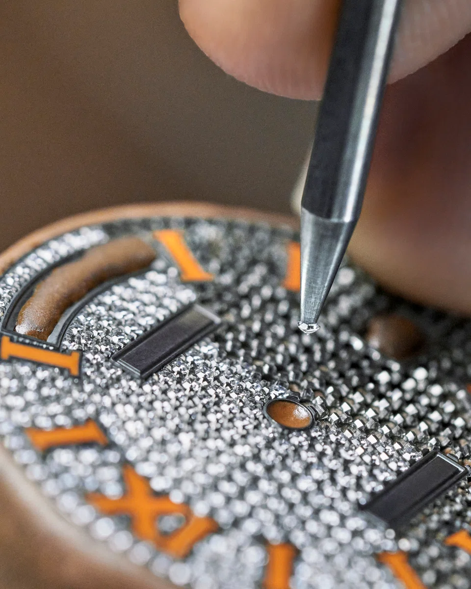 Setting diamonds into the dial. 