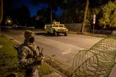 A National Guard soldier stands at a checkpoint enforcing a curfew in zones from 6.00 pm to 6.00 am as wildfires cause damage and loss in Santa Monica, California, Jan 11, 2025. 