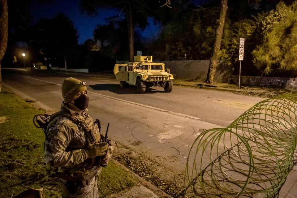 A National Guard soldier stands at a checkpoint enforcing a curfew in zones from 6.00 pm to 6.00 am as wildfires cause damage and loss in Santa Monica, California, Jan 11, 2025. 