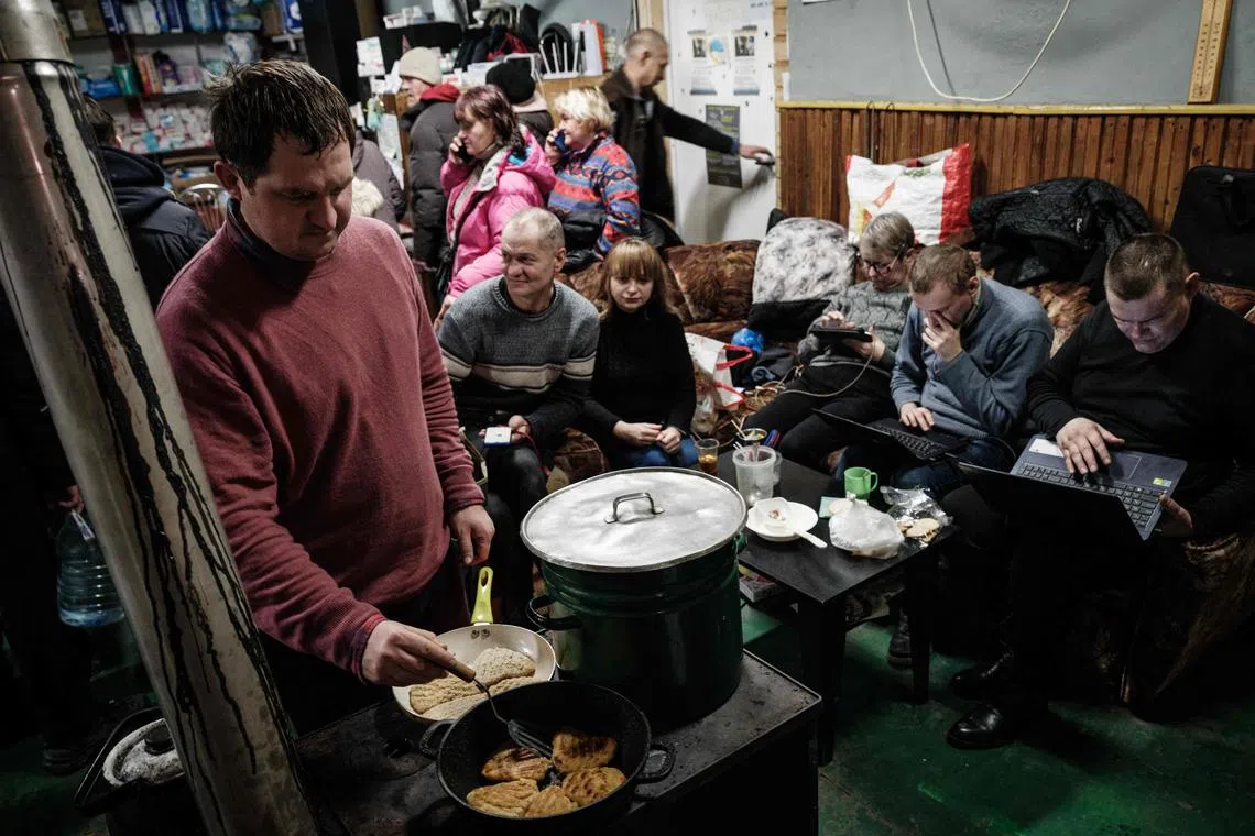 A volunteer cooks for people at a humanitarian centre in Bakhmut, Ukraine. While oligarchic capitalism persists in the country, its civil society is pushing back.