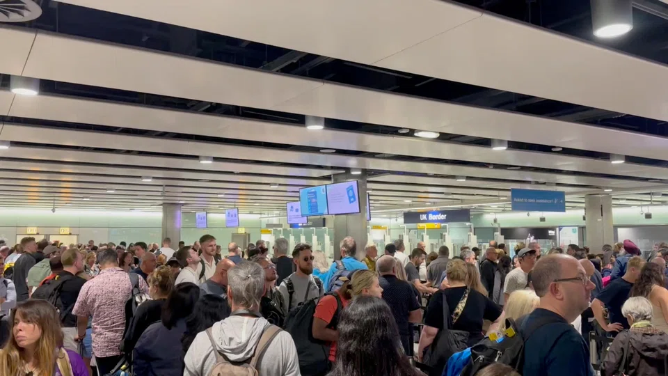 People wait in line at Heathrow airport, after the Border Force suffered a nationwide technical issue that affected passport control, London, Britain, May 7, 2024.
