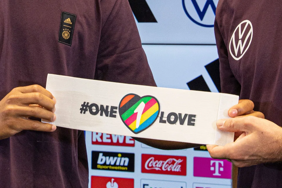 In September, Germany defender Thilo Kehrer (left) and midfielder Jonas Hofmann presented the captain's armband - a symbol against discrimination and for diversity - that many teams were planning to wear at the Fifa World Cup, to express condemnation for Qatar's human rights abuses.  