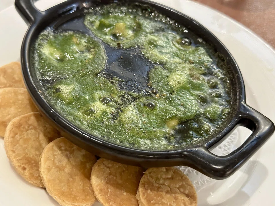 Comforting escargot in a bubbling garlic butter and parsley sauce.