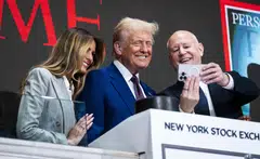 US President-elect Donald Trump and Melania Trump take a selfie with Jeff Sprecher, the chief executive of the Intercontinental Exchange as Trump takes part in the Wall Street bell ringing in Manhattan, New York, Dec 12, 2024.