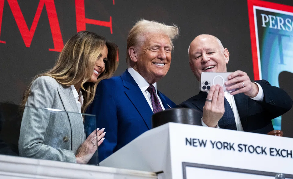 US President-elect Donald Trump and Melania Trump take a selfie with Jeff Sprecher, the chief executive of the Intercontinental Exchange as Trump takes part in the Wall Street bell ringing in Manhattan, New York, Dec 12, 2024.