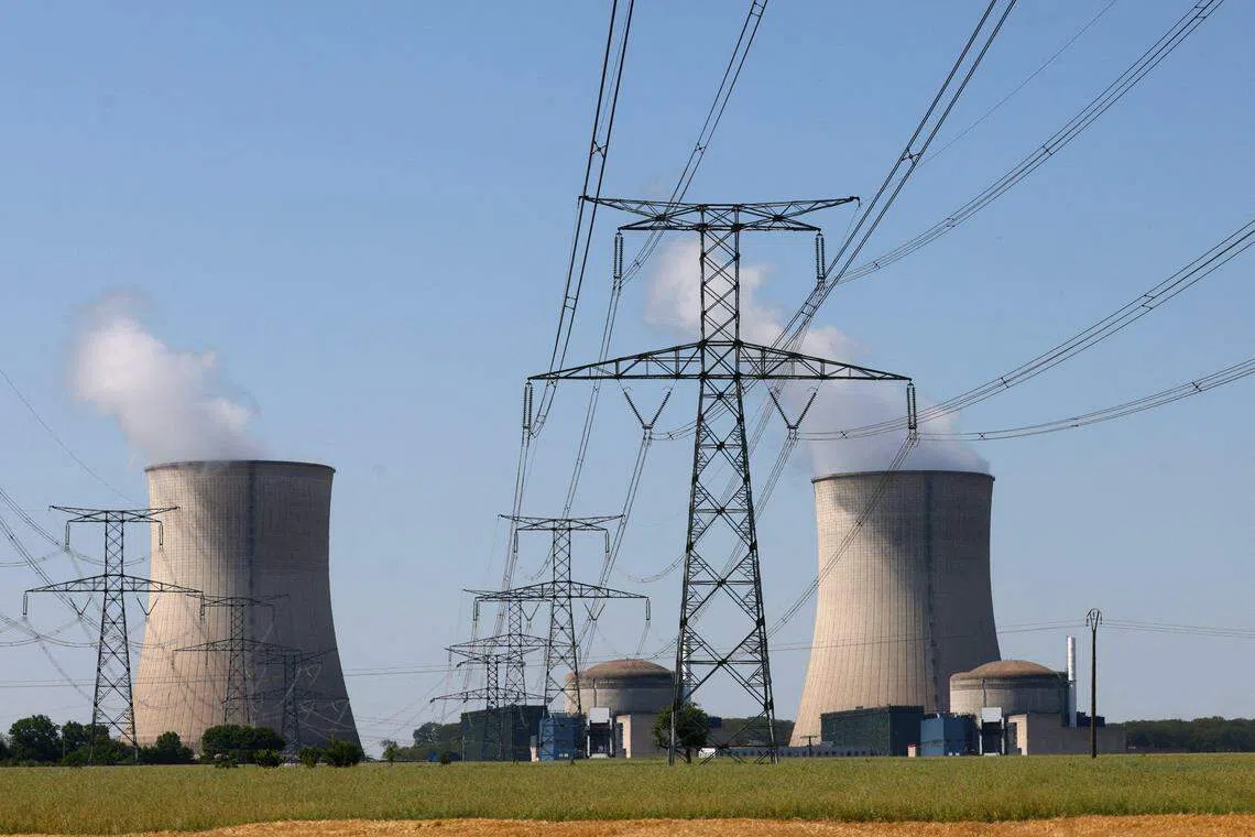 FILE PHOTO: A general view shows cooling towers and reactors of the Electricite de France (EDF) nuclear power plant in Cattenom, France, June 13, 2023. REUTERS/Yves Herman/File Photo