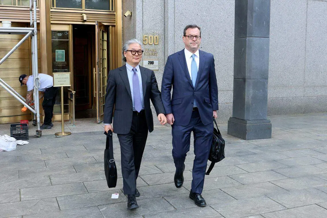 Bill Hwang (left) who was charged with 11 counts of securities fraud, wire fraud, conspiracy, racketeering and market manipulation, leaves Federal District court after the first day of his trial, Manhattan, New York, May 8, 2024. If convicted, he could spend the rest of his life in prison. 