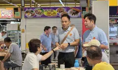 WP potential candidate Kenneth Foo (centre) speaking to residents at Block 16 food centre in East Coast GRC.