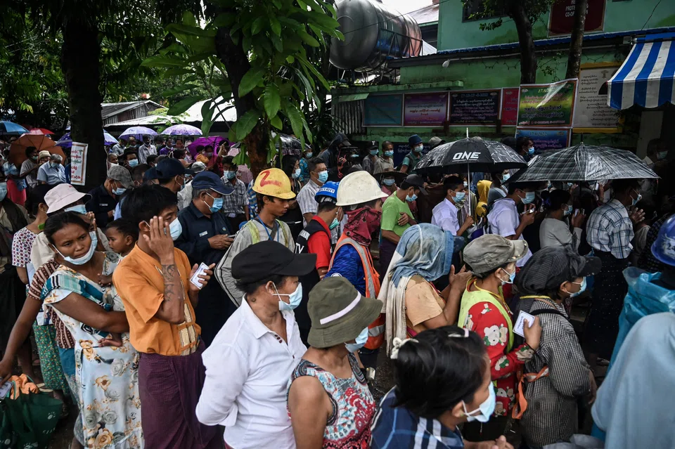 In this file photo taken in August 2022, people in Yangon queue to receive subsidised cooking oil. The Financial Action Task Force is mulling placing Myanmar on its blacklist, a move that will make the country even less appealing to foreign investors.