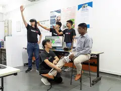 The students behind the Steady Lah app demonstrating how seniors can play VR games to test their mobility and memory, as well as motor and cognitive skills.